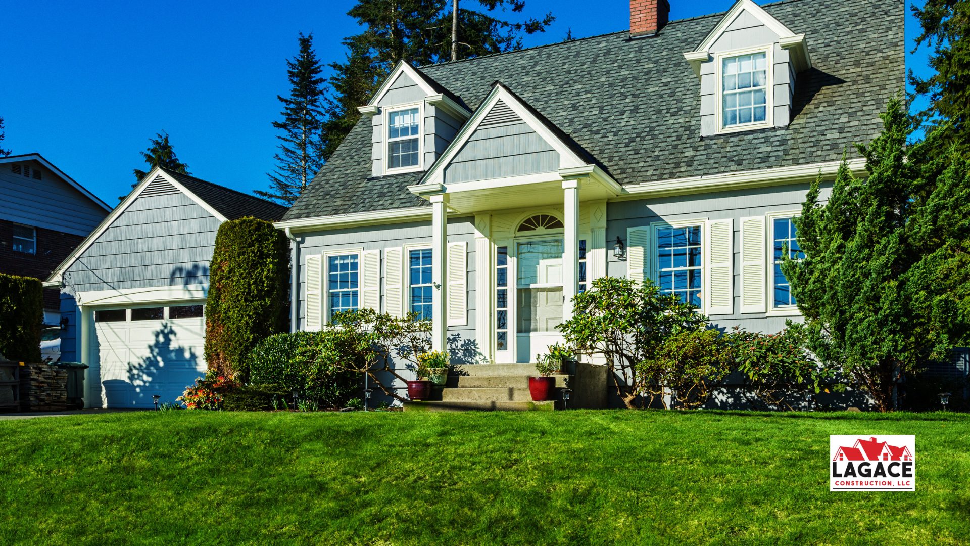 Cape Cod-style home in Hebron, CT with grey siding, white trim, dormer windows, and a welcoming front porch, built by Lagace Construction.