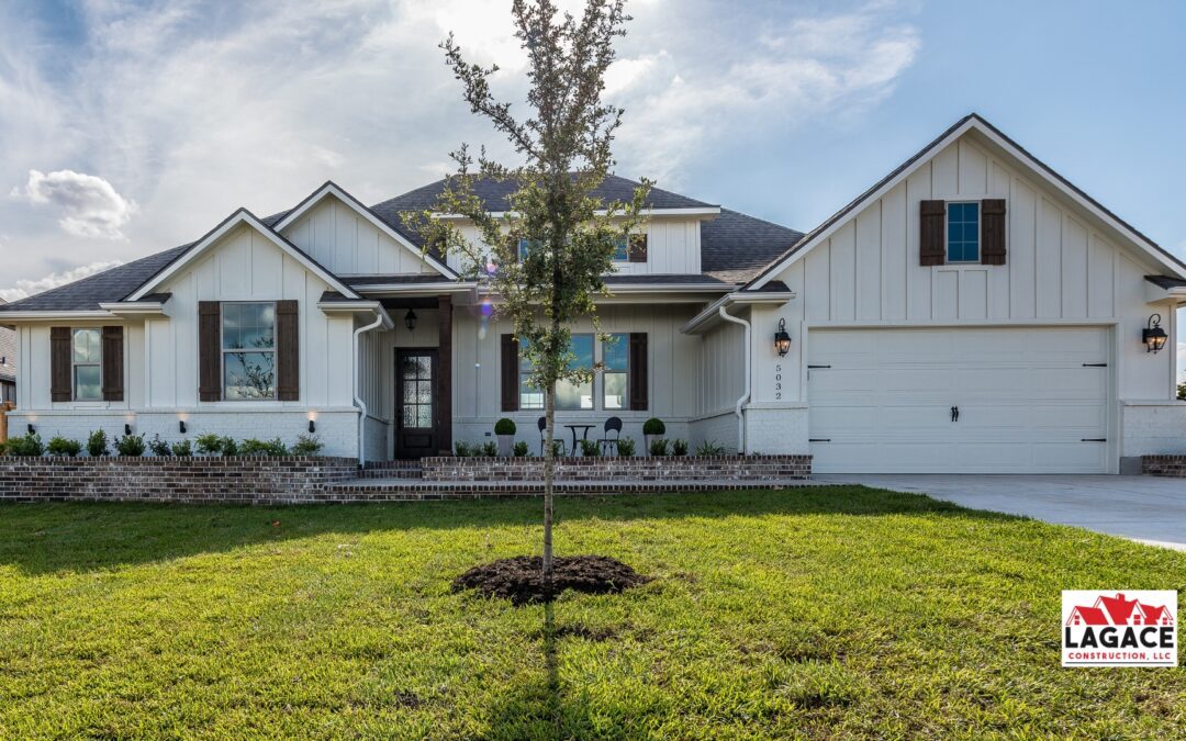 Modern farmhouse in Hebron, CT with board-and-batten siding, rustic wood shutters, and a covered front porch, built by Lagace Construction.